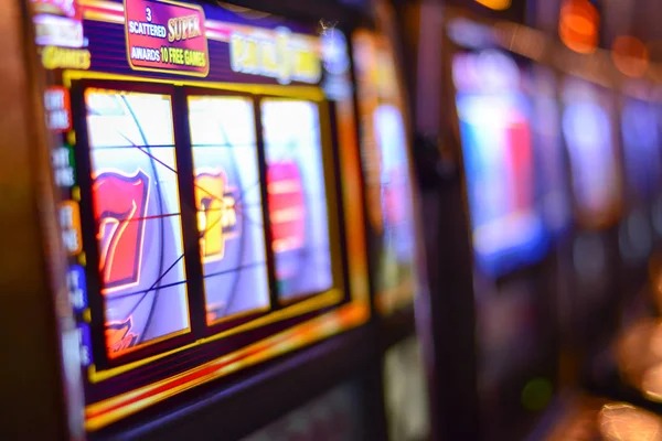 Live dealer rolling three dice in clear glass case with three-camera view